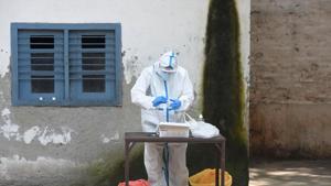 A health worker gears up in PPE coveralls to collect swab samples from people for Covid-19 rapid antigen testing and RT- PCR test, at Ramjas School, in Daryaganj.(Sonu Mehta/HT PHOTO) A health worker gears up in PPE coveralls to collect swab samples from people for Covid-19 rapid antigen testing and RT- PCR test, at Ramjas School, in Daryaganj.(Sonu Mehta/HT PHOTO)
