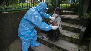 A health worker takes a nasal swab sample of a child to test for Covid-19 during a door to door test drive in Guwahati.(AP) A health worker takes a nasal swab sample of a child to test for Covid-19 during a door to door test drive in Guwahati.(AP)