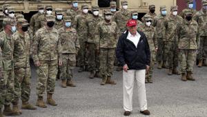 President Donald Trump stands with members of the Louisiana National Guard helping with recovery efforts from Hurricane Laura, Saturday.(AP photo) President Donald Trump stands with members of the Louisiana National Guard helping with recovery efforts from Hurricane Laura, Saturday.(AP photo)