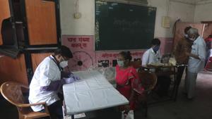 A doctor screens a woman for malaria symptoms, during a Covid-19 and malaria screening drive at a school in Dharavi, one of Asia's biggest slums, in Mumbai, India.(AP) A doctor screens a woman for malaria symptoms, during a Covid-19 and malaria screening drive at a school in Dharavi, one of Asia's biggest slums, in Mumbai, India.(AP)