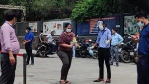 The examinees stood in queues and were allowed entry into a test centre in a staggered manner, after being sanitised at the gate.(HT) The examinees stood in queues and were allowed entry into a test centre in a staggered manner, after being sanitised at the gate.(HT)