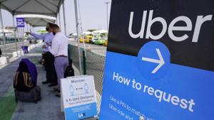 Travelers request an Uber ride at Los Angeles International Airport's LAX-it pick up terminal.(AP) Travelers request an Uber ride at Los Angeles International Airport's LAX-it pick up terminal.(AP)