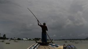 An Indian man rows a boat through floodwaters in Gagolmari village, Morigaon district, Assam, India.(AP) An Indian man rows a boat through floodwaters in Gagolmari village, Morigaon district, Assam, India.(AP)