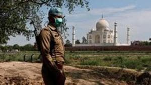 A policeman wearing a protective mask stands guard near the Taj Mahal amid the coronavirus pandemic in Uttar Pradesh’s Agra.(REUTERS PHOTO.) A policeman wearing a protective mask stands guard near the Taj Mahal amid the coronavirus pandemic in Uttar Pradesh’s Agra.(REUTERS PHOTO.)