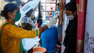 A community health volunteer checks the temperature of a girl during a check-up campaign for Covid-19, at a slum in Mumbai.(Reuters File Photo) A community health volunteer checks the temperature of a girl during a check-up campaign for Covid-19, at a slum in Mumbai.(Reuters File Photo)