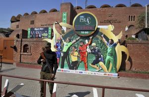 In this Monday, Feb. 17, 2020 photo, a police officer stands guard next to poster of cricket players displayed outside the Gaddafi stadium for upcoming Pakistan Super League, in Lahore, Pakistan.(AP) In this Monday, Feb. 17, 2020 photo, a police officer stands guard next to poster of cricket players displayed outside the Gaddafi stadium for upcoming Pakistan Super League, in Lahore, Pakistan.(AP)