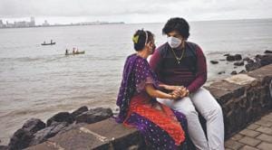 A masked couple sits by the Arabia Sea in Mumbai.(Sooni Taraporevala) A masked couple sits by the Arabia Sea in Mumbai.(Sooni Taraporevala)