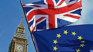 An EU flag and a Britain flag held by a demonstrator is seen with the Big Ben in central London. An EU flag and a Britain flag held by a demonstrator is seen with the Big Ben in central London.