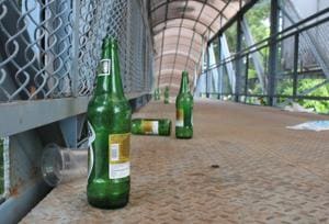 Beer bottles, waste lie scattered on a foot overbridge in Mohali.(HT Photo) Beer bottles, waste lie scattered on a foot overbridge in Mohali.(HT Photo)