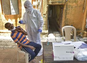 A healthcare worker collects swab sample of the resident at Goregaon in Mumbai. India’s Covid-19 tally is now at 4,204,613 and 71,642 people have died so far.(Pratik Chorge/HT Photo) A healthcare worker collects swab sample of the resident at Goregaon in Mumbai. India’s Covid-19 tally is now at 4,204,613 and 71,642 people have died so far.(Pratik Chorge/HT Photo)