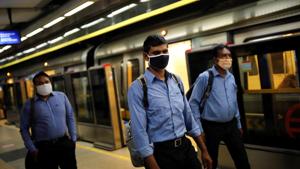 Commuters wearing face masks walk at a Delhi metro train station, on the first day of the restart of their operations, amidst the spread of coronavirus disease in New Delhi.(REUTERS) Commuters wearing face masks walk at a Delhi metro train station, on the first day of the restart of their operations, amidst the spread of coronavirus disease in New Delhi.(REUTERS)