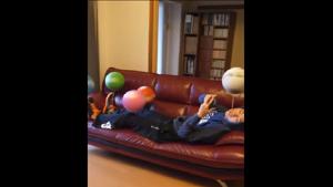 The clip opens to show the man lying on a couch holding a stick between his teeth with a spinning football atop it.(Instagram/@RyuTricks) The clip opens to show the man lying on a couch holding a stick between his teeth with a spinning football atop it.(Instagram/@RyuTricks)