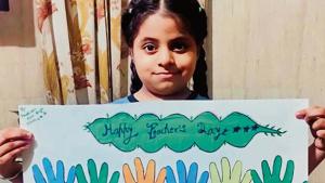 A student of BVM School, Chandigarh Road, Ludhiana showing her poster on the occasion.(HT)