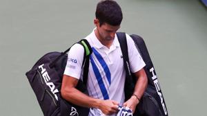 Novak Djokovic walks off the court after being disqualified.(Getty Images) Novak Djokovic walks off the court after being disqualified.(Getty Images)