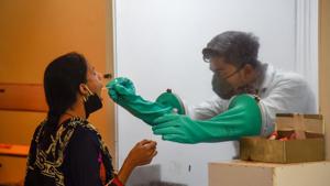 A health worker collects a swab sample at SNDT college in Pune, India, on Tuesday, September 8, 2020.(Sanket Wankhade/HT) A health worker collects a swab sample at SNDT college in Pune, India, on Tuesday, September 8, 2020.(Sanket Wankhade/HT)