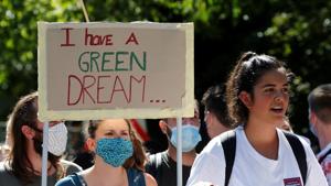 An activist holds a placard during a "rise up for change" national day of protest and action against climate change in Lausanne, Switzerland.(REUTERS) An activist holds a placard during a "rise up for change" national day of protest and action against climate change in Lausanne, Switzerland.(REUTERS)