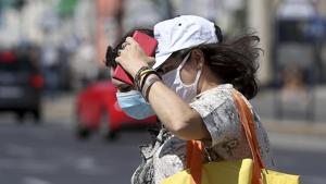 People wear face mask as they cross a street in Vienna, Austria on August 19, 2020.(AP Photo) People wear face mask as they cross a street in Vienna, Austria on August 19, 2020.(AP Photo)
