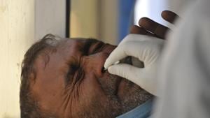 A paramedic taking a nasal swab sample in Srinagar.(HT File) A paramedic taking a nasal swab sample in Srinagar.(HT File)