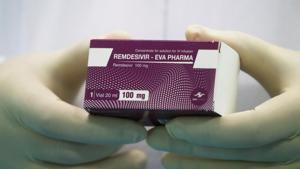A lab technicians holds the coronavirus disease (Covid-19) treatment drug 