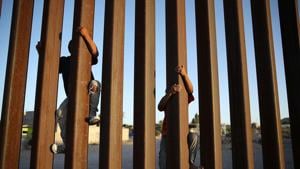 In this file photo taken on June 24, 2018 children climb up the Mexican side of the US-Mexico border fence in Sunland Park, New Mexico.(AFP)
