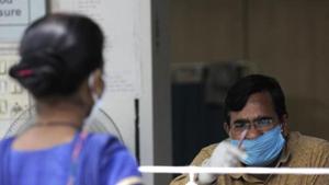 A health worker guides a woman towards a coronavirus disease testing centre in Noida.(Sunil Ghosh/HT Photo)