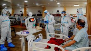 A Covid-19 patient before interacting with family members via a robot, at a Noida hospital on September 12.(PTI) A Covid-19 patient before interacting with family members via a robot, at a Noida hospital on September 12.(PTI)