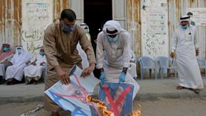 Palestinians burn pictures depicting Israeli Prime Minister Benjamin Netanyahu and US President Donald Trump during a protest against Bahrain's move to normalize relations with Israel, in the central Gaza Strip September 12, 2020.(REUTERS) Palestinians burn pictures depicting Israeli Prime Minister Benjamin Netanyahu and US President Donald Trump during a protest against Bahrain's move to normalize relations with Israel, in the central Gaza Strip September 12, 2020.(REUTERS)