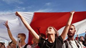 Opposition supporters carry a historical white-red-white flag of Belarus as they take part in a rally in Minsk.(Reuters) Opposition supporters carry a historical white-red-white flag of Belarus as they take part in a rally in Minsk.(Reuters)
