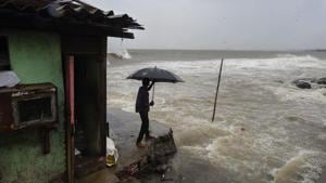 A man standing near a shanty built on the edge of the Arabian Sea at Bandra, as the waves turned choppy ahead of Cyclone Nisarga’s expected landfall in Mumbai on June 3, 2020.(PTI File Photo) A man standing near a shanty built on the edge of the Arabian Sea at Bandra, as the waves turned choppy ahead of Cyclone Nisarga’s expected landfall in Mumbai on June 3, 2020.(PTI File Photo)