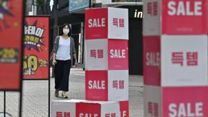 A woman walks past sale signs at the Myeongdong shopping district in Seoul. Covid--ravaged economies across the Asia Pacific are expected to contract this year for the first time in nearly six decades.(AFP) A woman walks past sale signs at the Myeongdong shopping district in Seoul. Covid--ravaged economies across the Asia Pacific are expected to contract this year for the first time in nearly six decades.(AFP)