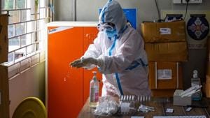 A health worker in PPE coveralls sanitizes her hands during coronavirus testing, at Aam Aadmi Mohalla Clinic in Tughlakabad, New Delhi.(Amal KS/HT Photo) A health worker in PPE coveralls sanitizes her hands during coronavirus testing, at Aam Aadmi Mohalla Clinic in Tughlakabad, New Delhi.(Amal KS/HT Photo)