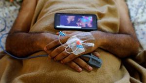 A patient suffering from the coronavirus disease (COVID-19), listens a song on a mobile phone at the Intensive Care Unit (ICU) of the Yatharth Hospital in Noida, on the outskirts of New Delhi, India, September 15, 2020. Picture taken September 15, 2020. (Representational image)(REUTERS) A patient suffering from the coronavirus disease (COVID-19), listens a song on a mobile phone at the Intensive Care Unit (ICU) of the Yatharth Hospital in Noida, on the outskirts of New Delhi, India, September 15, 2020. Picture taken September 15, 2020. (Representational image)(REUTERS)