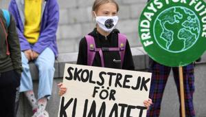 FILE PHOTO: Swedish climate activist Greta Thunberg holds a poster reading FILE PHOTO: Swedish climate activist Greta Thunberg holds a poster reading