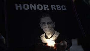 A woman holds a candle as people pay their respects to Ruth Bader Ginsburg near the US Supreme Court in Washington, DC on September 19.(AFP) A woman holds a candle as people pay their respects to Ruth Bader Ginsburg near the US Supreme Court in Washington, DC on September 19.(AFP)