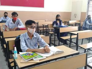 Students of Government Model High School, Sector 45, Chandigarh, maintaining social distancing while attending class on Monday.(Keshav Singh/HT)