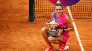 Tennis - WTA Premier 5 - Italian Open - Foro Italico, Rome, Italy - September 21, 2020 Romania's Simona Halep as she celebrates winning the final with the trophy after Czech Republic's Karolina Pliskova retired from the match after sustaining an injury Clive Brunskill/Pool via REUTERS(REUTERS) Tennis - WTA Premier 5 - Italian Open - Foro Italico, Rome, Italy - September 21, 2020 Romania's Simona Halep as she celebrates winning the final with the trophy after Czech Republic's Karolina Pliskova retired from the match after sustaining an injury Clive Brunskill/Pool via REUTERS(REUTERS)