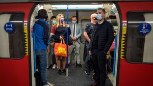 Commuters wearing face masks or covering due to the Covid-19 pandemic, stand aboard a Victoria Line London underground tube train as they travel during the evening 'rush hour' in central London on September 23.(AFP) Commuters wearing face masks or covering due to the Covid-19 pandemic, stand aboard a Victoria Line London underground tube train as they travel during the evening 'rush hour' in central London on September 23.(AFP)