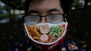 Japanese designer Takahiro Shibata's glasses fog up as he wears a protective mask that looks like a steaming bowl of ramen noodle soup.(REUTERS) Japanese designer Takahiro Shibata's glasses fog up as he wears a protective mask that looks like a steaming bowl of ramen noodle soup.(REUTERS)