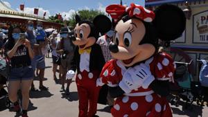 The iconic cartoon characters Minnie and Mickey Mouse walk with the visitors at the Hong Kong Disneyland .(AP) The iconic cartoon characters Minnie and Mickey Mouse walk with the visitors at the Hong Kong Disneyland .(AP)