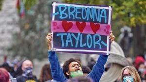 A protester holds up a sign after a grand jury announced its decision in the case of Breonna Taylor’s death , in Louisville, Kentucky. A protester holds up a sign after a grand jury announced its decision in the case of Breonna Taylor’s death , in Louisville, Kentucky.