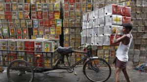 A man loads empty containers of edible oil onto a tricycle at a roadside in Kolkata, India.(REUTERS) A man loads empty containers of edible oil onto a tricycle at a roadside in Kolkata, India.(REUTERS)