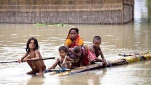 Flood affected people use rafts made of banana trunks to move to safer places at Mayong in Morigaon district of Assam.(PTI) Flood affected people use rafts made of banana trunks to move to safer places at Mayong in Morigaon district of Assam.(PTI)