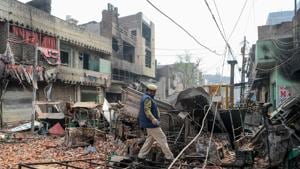 In this file photo taken on February 26, 2020, a Delhi police personnel patrols near burnt-out and damaged residential premises and shops following clashes between people supporting and opposing a contentious amendment to India's citizenship law, New Delhi(AFP) In this file photo taken on February 26, 2020, a Delhi police personnel patrols near burnt-out and damaged residential premises and shops following clashes between people supporting and opposing a contentious amendment to India's citizenship law, New Delhi(AFP)