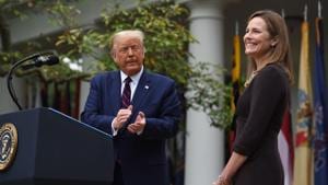 US President Donald Trump announces his US Supreme Court nominee, Judge Amy Coney Barrett (right), in the Rose Garden of the White House in Washington, DC on September 26.(AFP) US President Donald Trump announces his US Supreme Court nominee, Judge Amy Coney Barrett (right), in the Rose Garden of the White House in Washington, DC on September 26.(AFP)