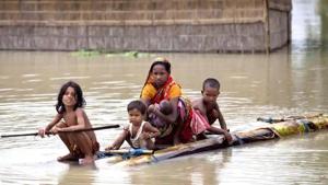 Flood affected people use rafts made of banana trunks to move to safer places at Mayong in Morigaon district of Assam.(PTI)