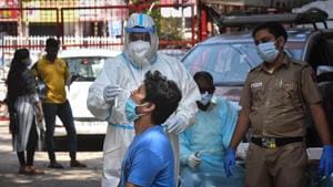 A health worker in PPE coveralls collects a swab samples for coronavirus testing, at Hudson Lane, in New Delhi on Sunday(Sanchit Khanna/HT Photo) A health worker in PPE coveralls collects a swab samples for coronavirus testing, at Hudson Lane, in New Delhi on Sunday(Sanchit Khanna/HT Photo)
