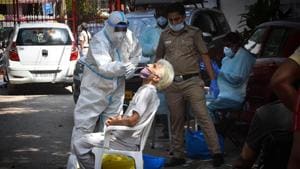 A health worker in PPE coveralls collects a swab samples for coronavirus testing, at Hudson Lane, in New Delhi on Sunday.(Sanchit Khanna/HT PHOTO) A health worker in PPE coveralls collects a swab samples for coronavirus testing, at Hudson Lane, in New Delhi on Sunday.(Sanchit Khanna/HT PHOTO)