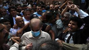 Shahbaz Sharif (Centre wearing blue mask), Pakistani opposition leader and brother of former prime minister Nawaz Sharif, comes out from the Lahore high court surrounded by supporters after the court rejected his bail plea in a money laundering and assets beyond income case.(AFP) Shahbaz Sharif (Centre wearing blue mask), Pakistani opposition leader and brother of former prime minister Nawaz Sharif, comes out from the Lahore high court surrounded by supporters after the court rejected his bail plea in a money laundering and assets beyond income case.(AFP)