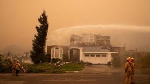 Firefighters surround a residence after it was struck by the Shady Fire in the Skyhawk neighborhood of Santa Rosa, California.(REUTERS) Firefighters surround a residence after it was struck by the Shady Fire in the Skyhawk neighborhood of Santa Rosa, California.(REUTERS)