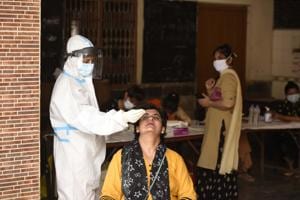 A health worker collecting a swab sample at Bhagwati Vidya Mandir School in Madanpuri, Gurugram, on Tuesday.(Parveen Kumar/HT) A health worker collecting a swab sample at Bhagwati Vidya Mandir School in Madanpuri, Gurugram, on Tuesday.(Parveen Kumar/HT)